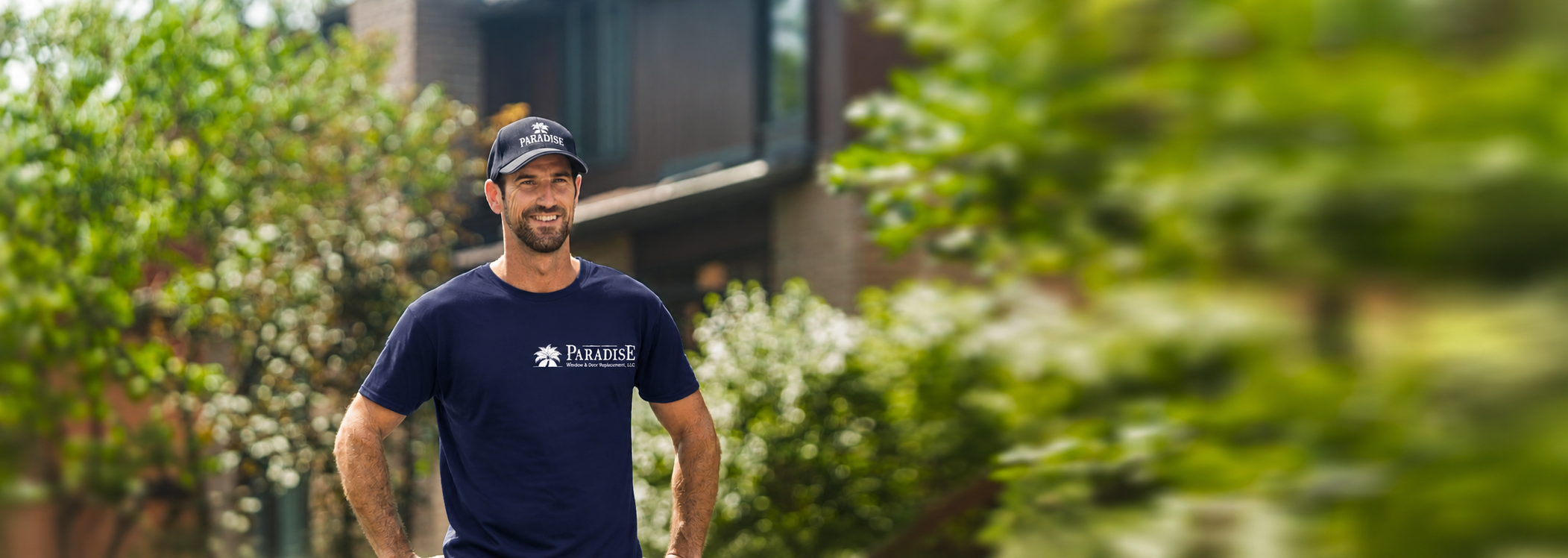 A Bavarian window installer poses in front of a Naples, Florida home.